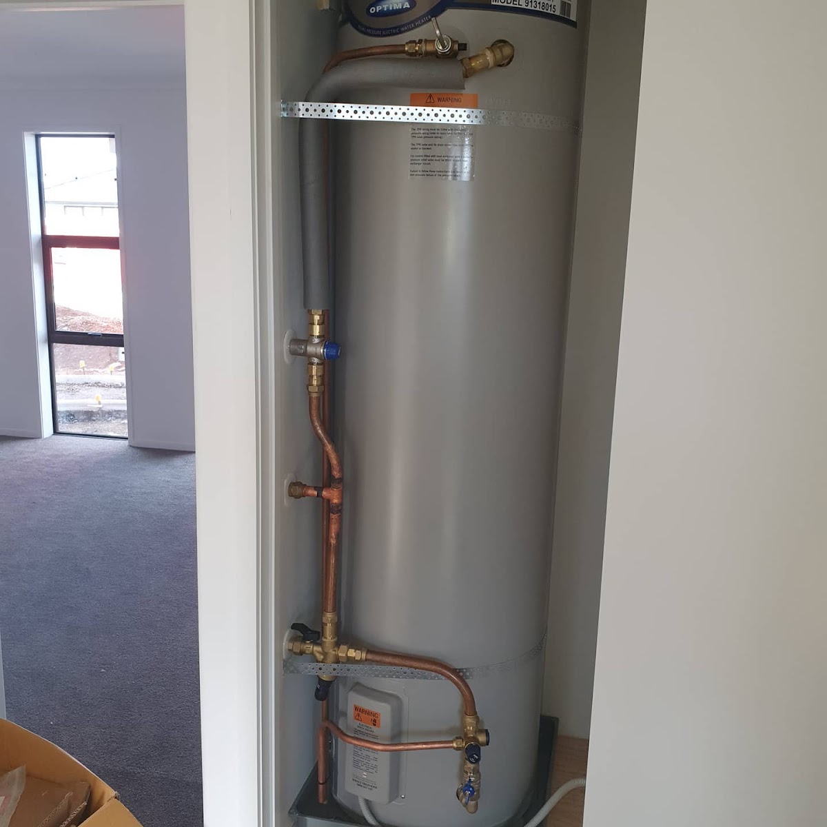 Hot water cylinder installed with neat copper pipework
