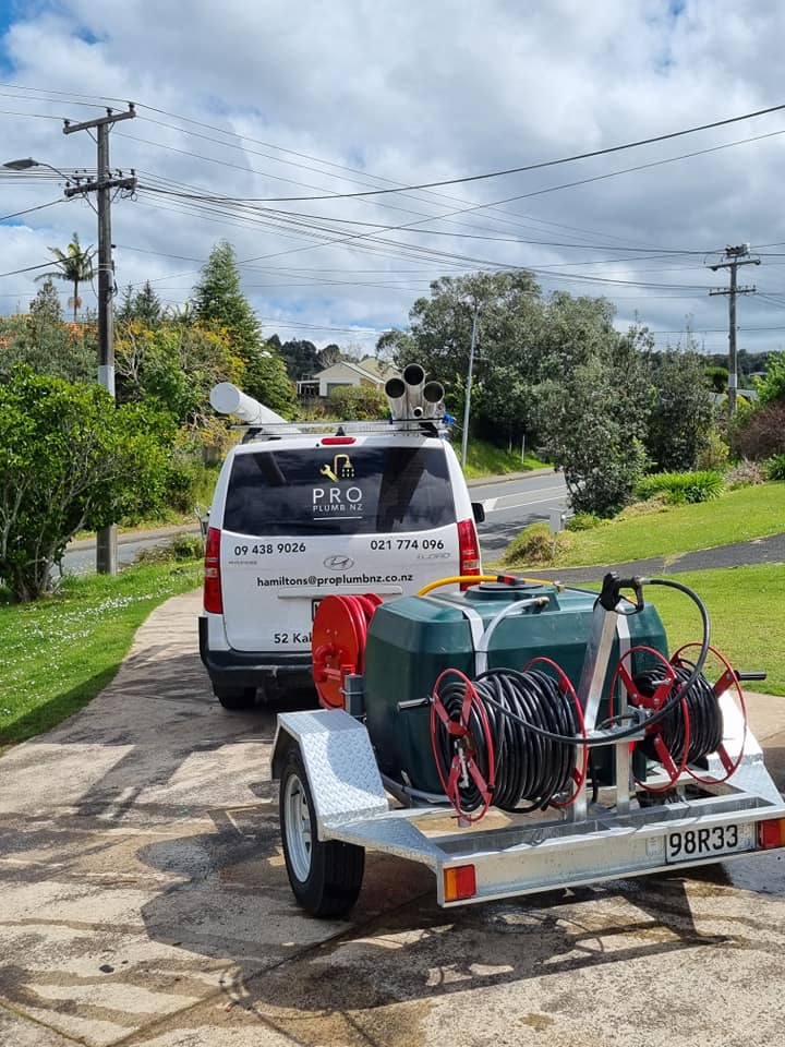 Pro Plumb NZ branded van and jetting trailer in a Whangārei driveway